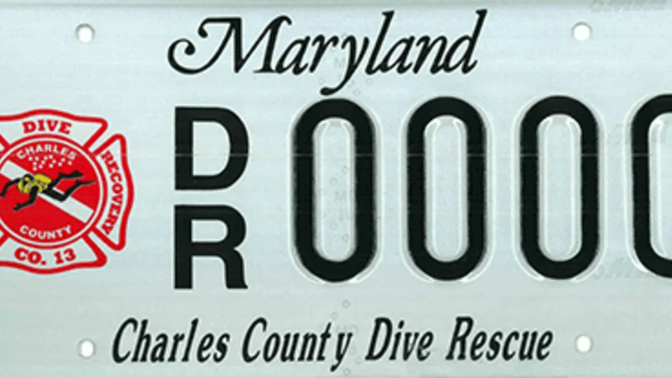 Maryland license plate with "DR 0000" and "Charles County Dive Rescue" text. A red and white logo is on the left.