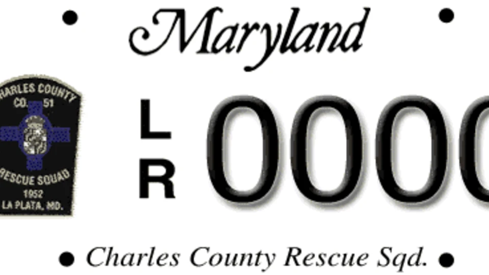 White license plate with "Maryland" in cursive script, a badge for "Charles County Co. 51 Rescue Squad 1952 La Plata, MD." and the letters/numbers "LR 0000."