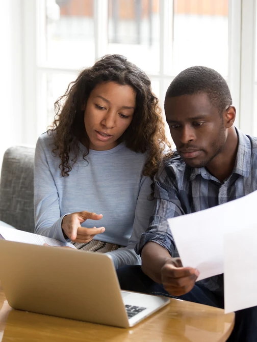 people looking at laptop documents