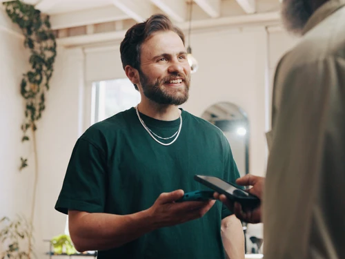 man holding phone tap with other phone