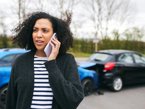 person calling insurance after a crash