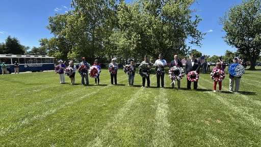 people holding wreaths