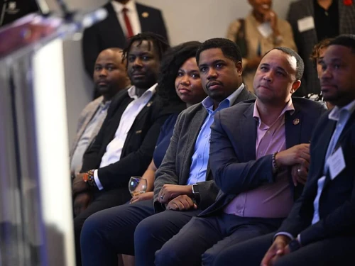 Audience members listening to Governor Moore during the Baltimore Corps Anniversary gathering