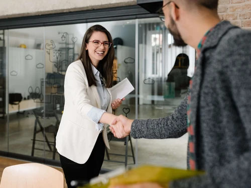 Woman and man shaking hands in an office