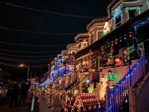 Holiday lights at night on rowhouses along 34th Street in Baltimore